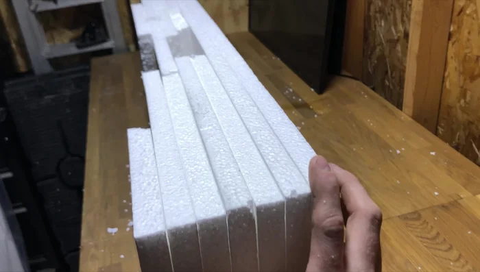 Carve out desired shapes and features into the styrofoam background. This step allows for creating caves, rock formations, or other creative designs. Don't worry about being perfect; the concrete mix will help refine the look.