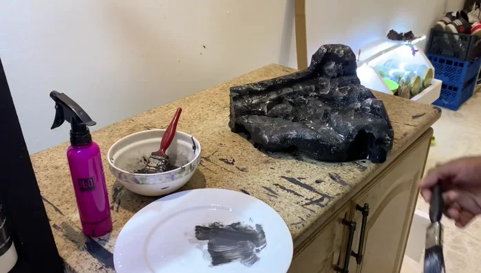 Paint the artificial rocks using acrylic paint. Allow them to dry completely for 24 hours.