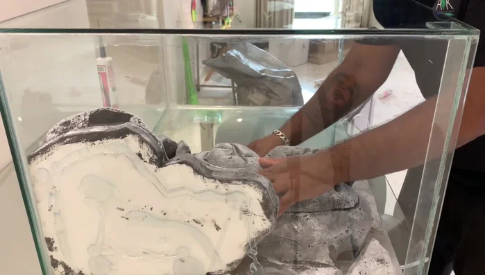 Install the 3D background into the aquarium tank using a generous amount of silicone to prevent it from floating.