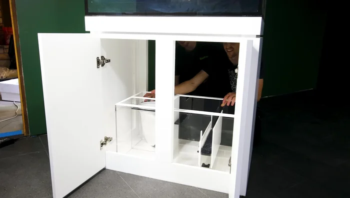 Install bulkheads and plumbing components in the sump and overflow box, using PVC cement and hose clamps to create watertight seals.