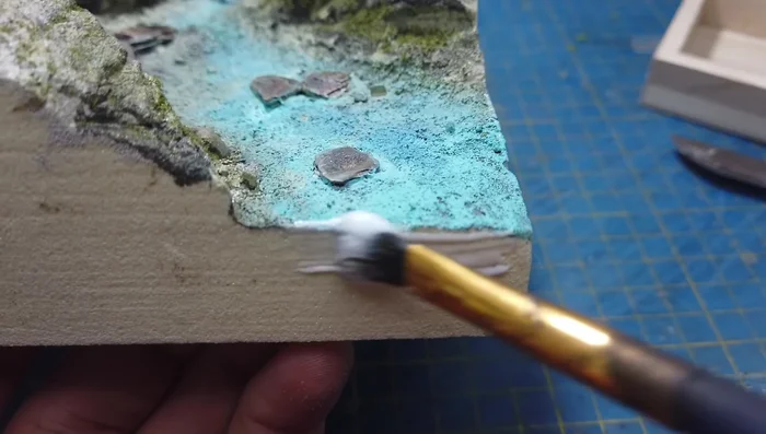 Mixing and pouring tinted epoxy resin. (Note: The video highlights the mistake of insufficient sealant for the sculpture block, leading to issues.)