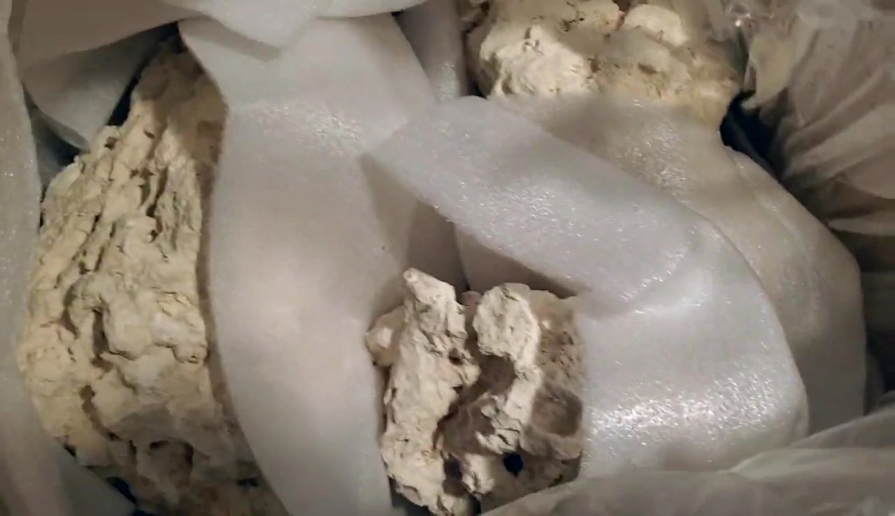 A close-up of the relatively clean bag of base rock after opening.