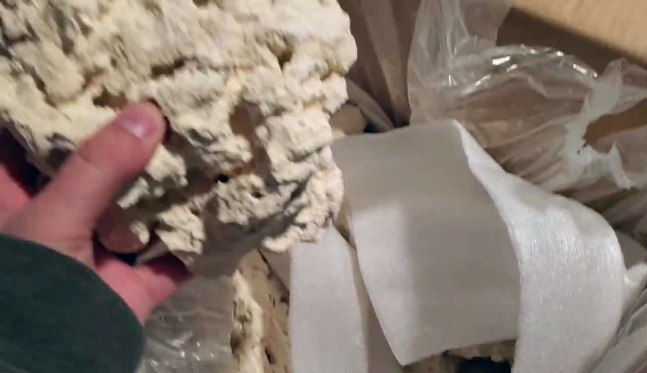 The reviewer holding one of the larger base rock pieces.