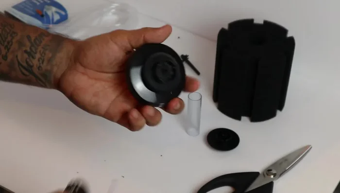 Assemble the filter: Attach the two columns to the base. Re-attach the sponge.