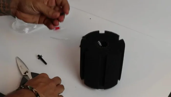 Connect the adapter and tubing: Carefully insert the small adapter piece into the tubing. Reconnect the sponge to the columns.