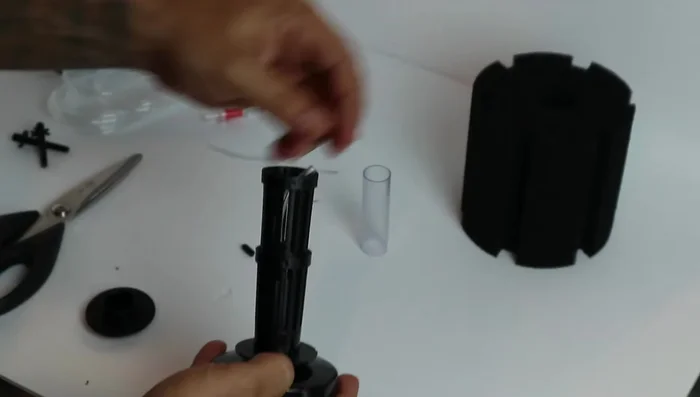 Connect the adapter and tubing: Carefully insert the small adapter piece into the tubing. Reconnect the sponge to the columns.