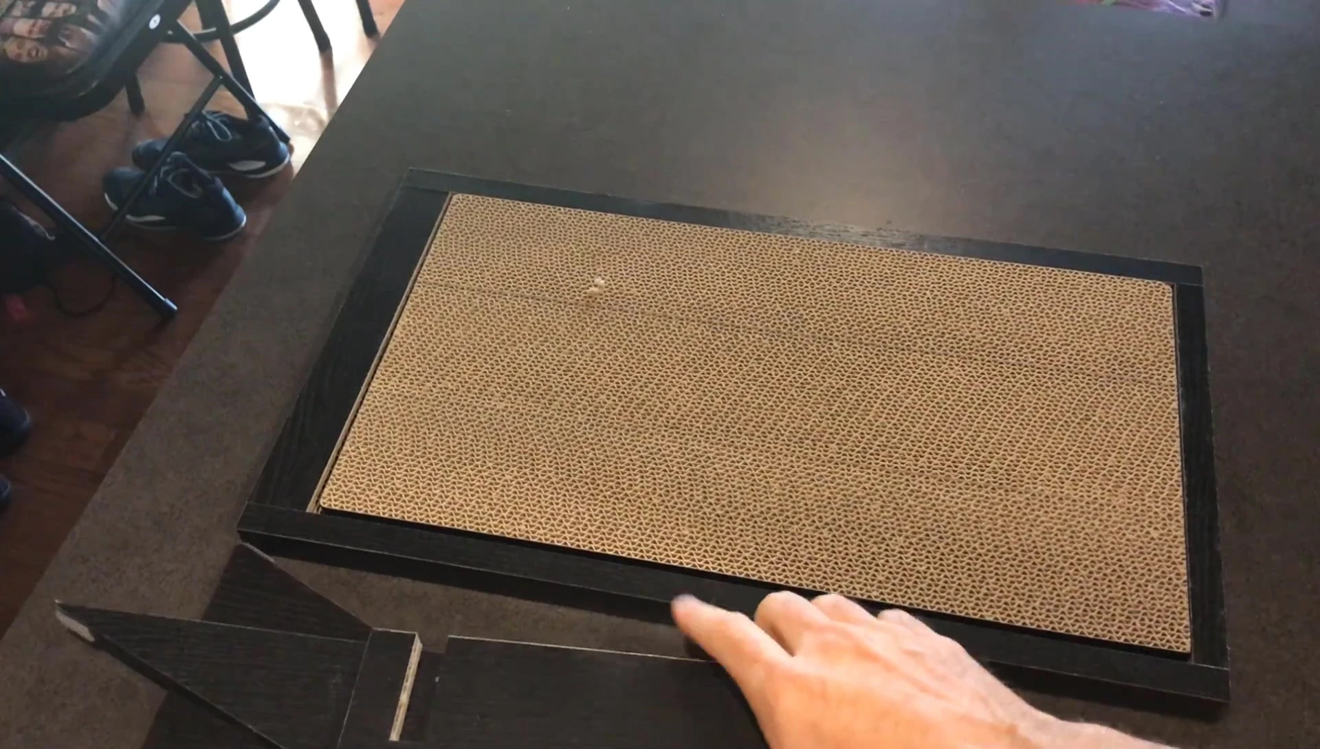 Attaching the scratching pad to the base using Velcro.