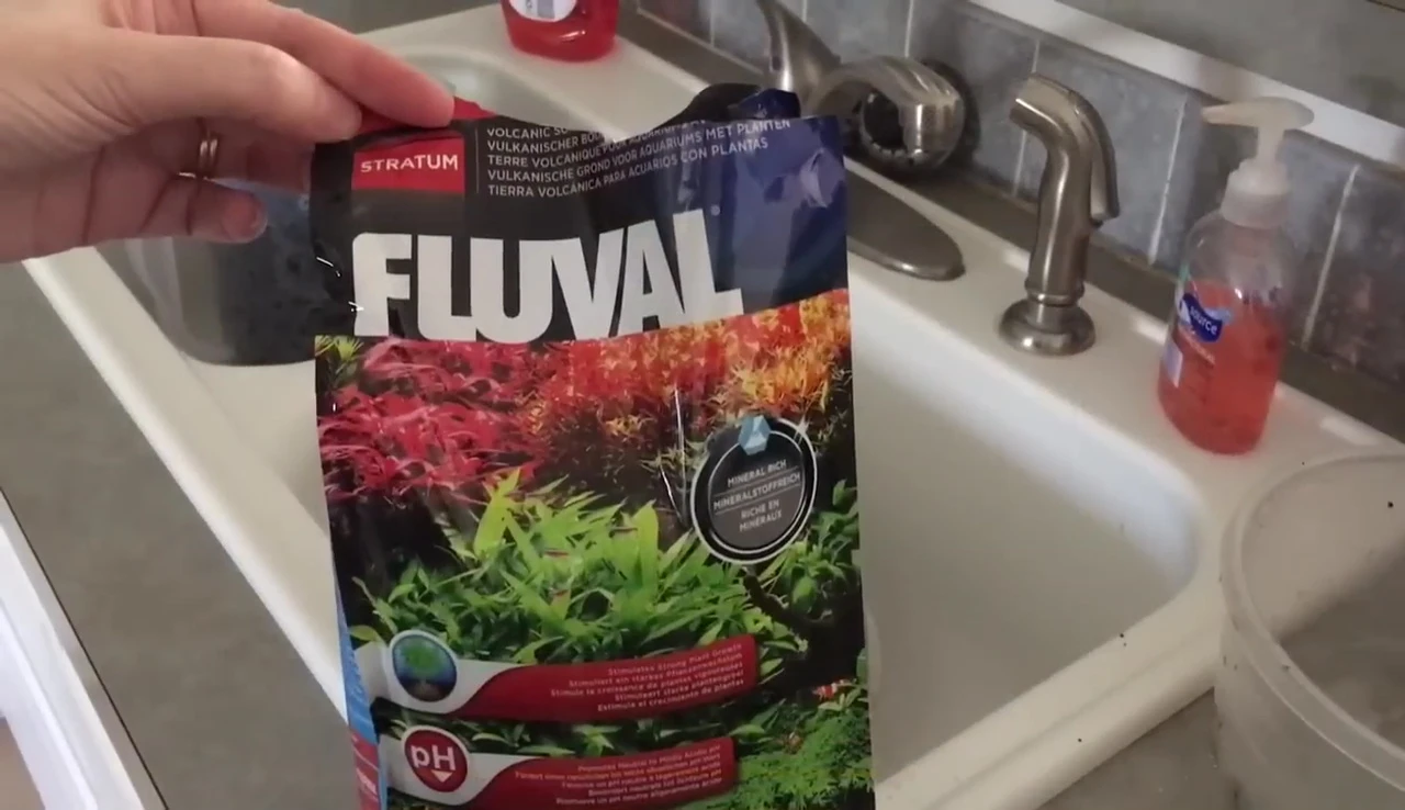 Close-up of the Fluval stratum being added to the tank