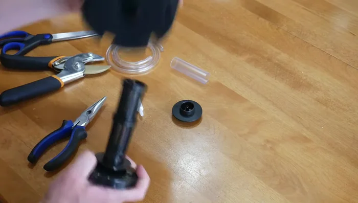 Pull off the sponge and separate the bottom weighted part from the internal working of the filter.