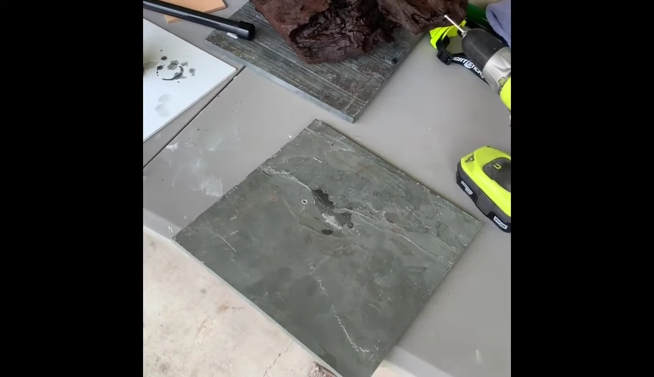 The speaker pointing out the location of the slate tiles within Home Depot.