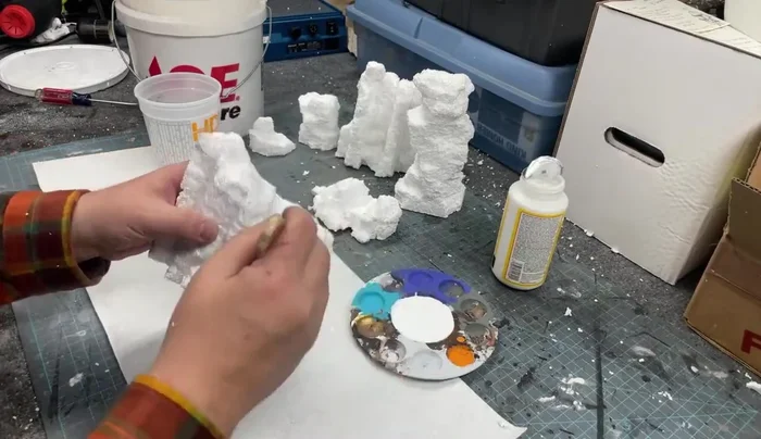 Use a wet brush to smooth and blend the sand, creating a more natural texture.