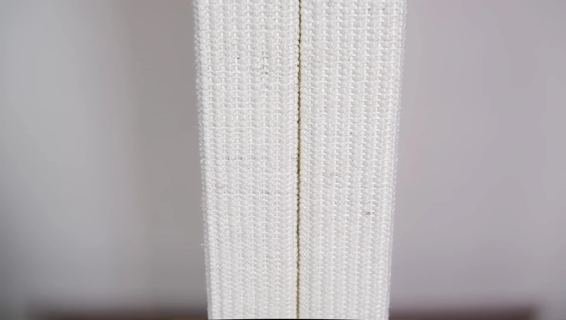 The tall scratching post with a cat near it.