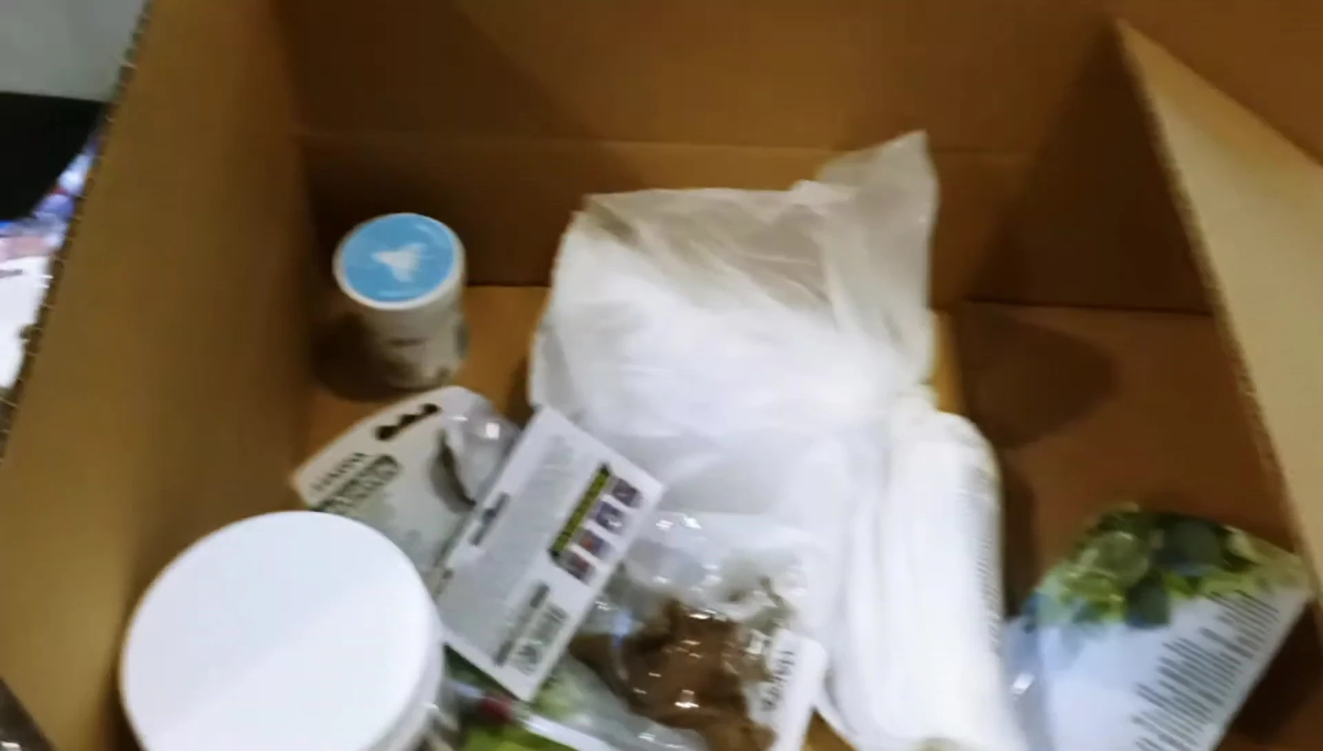 The YouTuber holding up several items from the unboxing, conveying satisfaction.