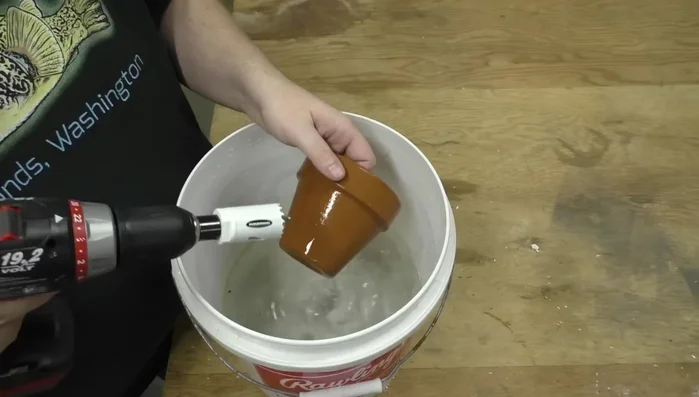 Start drilling slowly, using the pilot bit to guide the hole saw, frequently dipping the bit in water to prevent overheating.