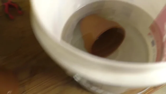 Soak flower pots overnight in a bucket of water to soften the clay.