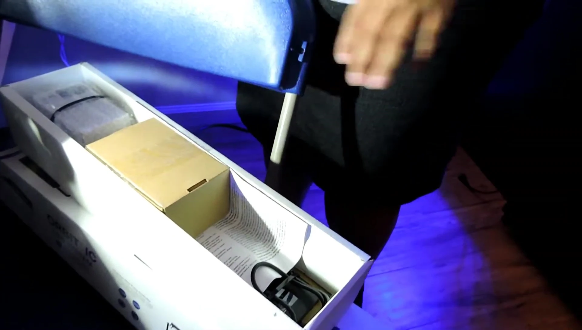 The speaker struggles to remove the tape from a box