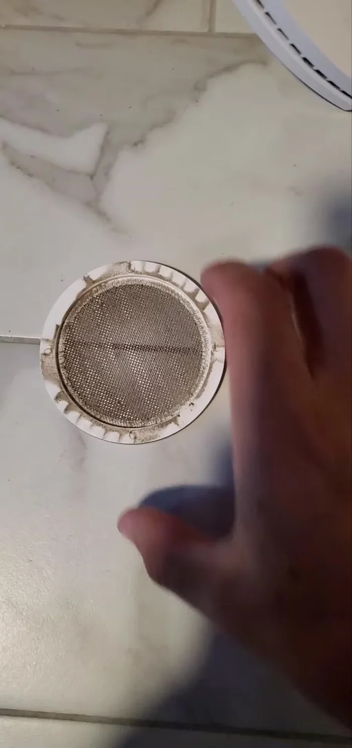 Rinse the fan cover in the sink.