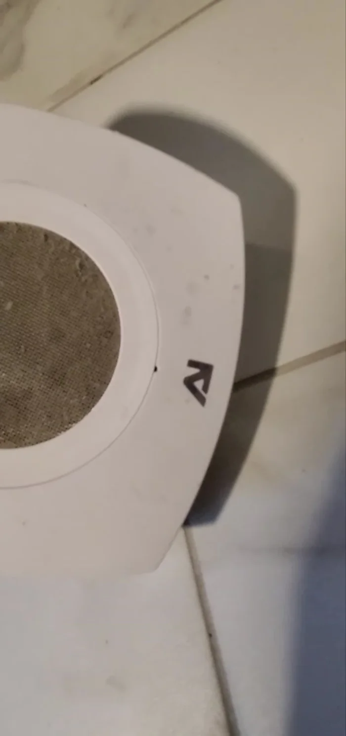 Use a pointed object, like a paper clip, to release the catch and remove the fan cover.