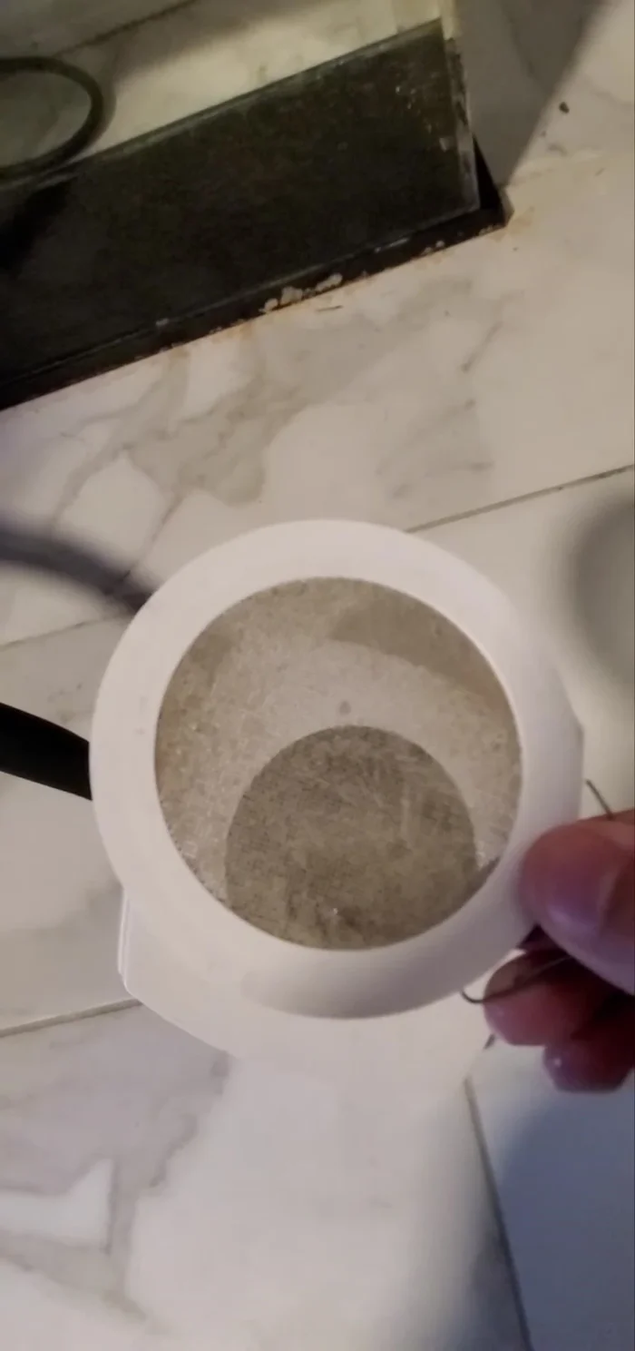 Rinse the fan cover in the sink.