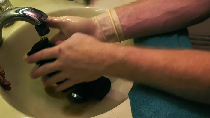 Rinse the sponge filter under running water, squeezing it repeatedly to remove loose debris. Continue until the water runs mostly clear.