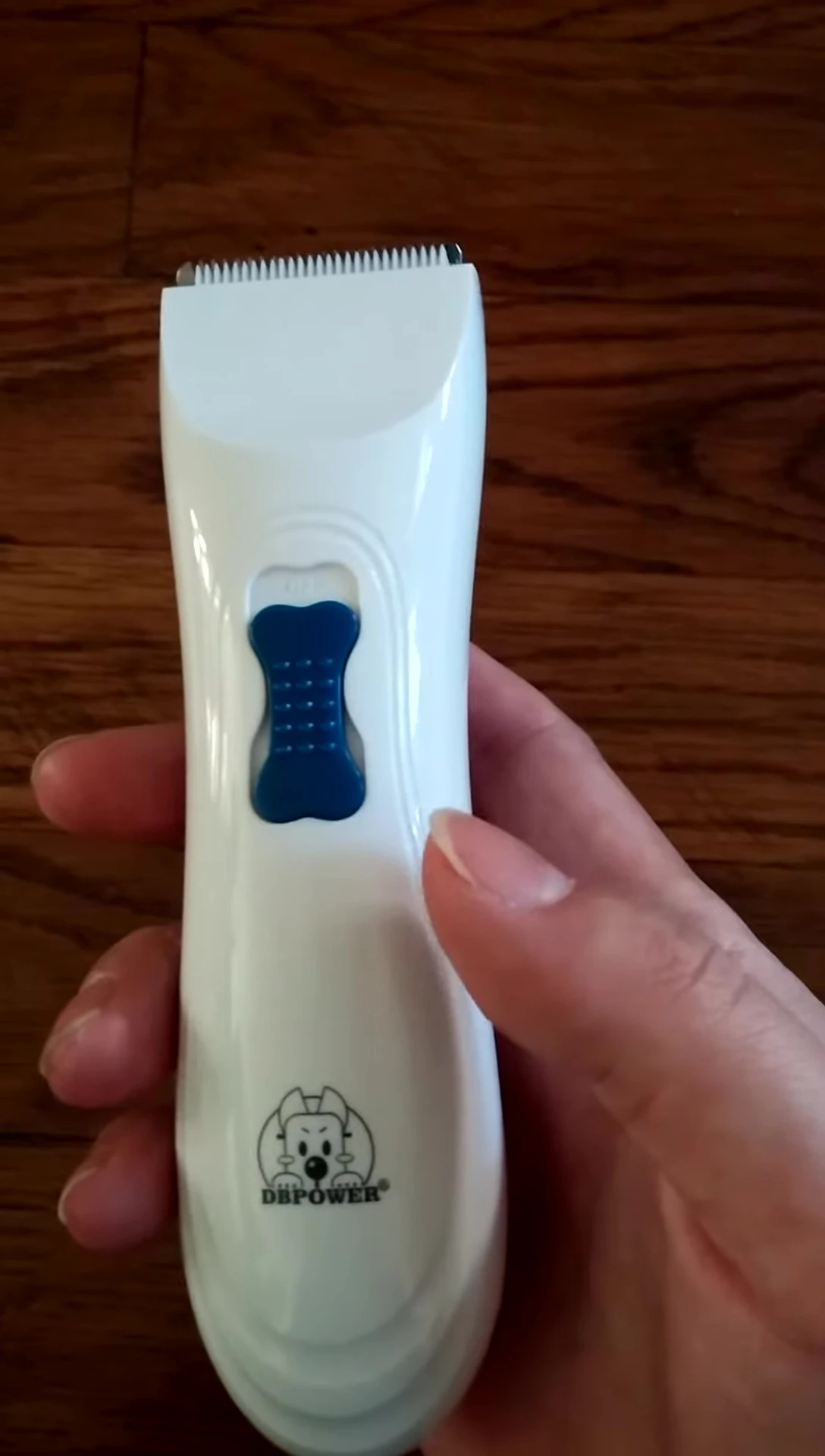 Close-up of the cordless pet hair trimmer in hand.