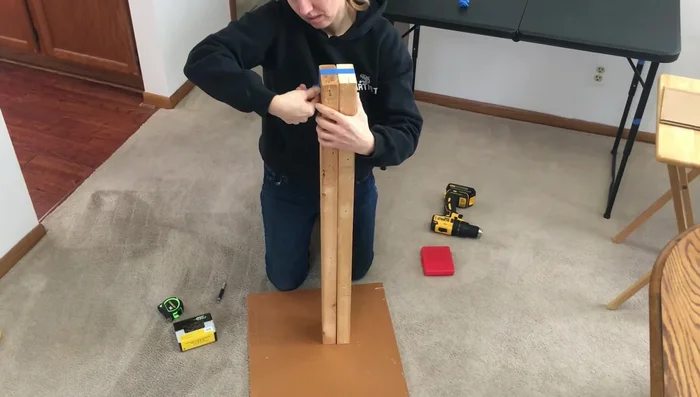 Tape and screw the two two-by-fours together to create a sturdy post.