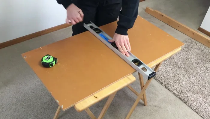 Tape and screw the two two-by-fours together to create a sturdy post.