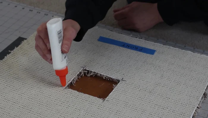 Attach the carpet to the plywood base using carpet tape (or hot glue/double-sided tape).