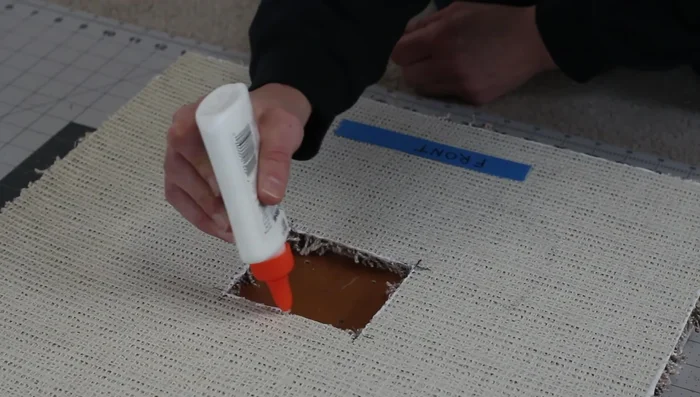 Wrap the sisal rope around the two-by-four structure using hot glue and staples for a secure hold.