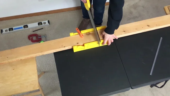 Tape and screw the two two-by-fours together to create a sturdy post.