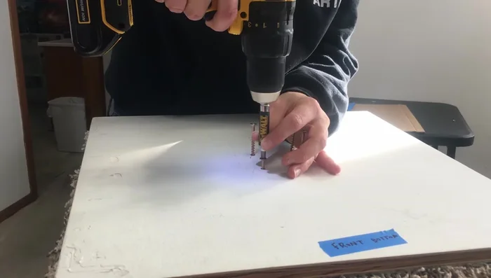 Attach the post to the plywood base using screws.