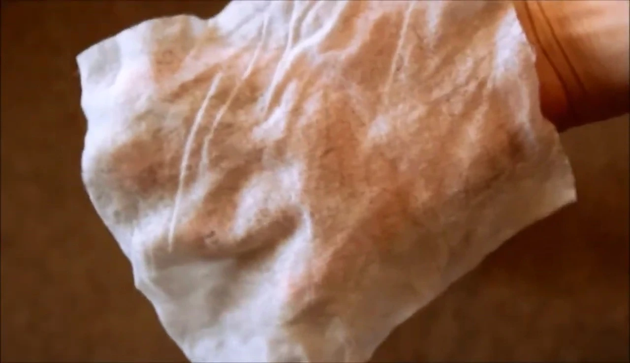 Close-up of Grooming Jeanne wipe showing dirt removed