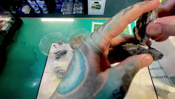 Place the glue-saturated tissue between the rocks, pressing firmly to create a strong bond. A chemical reaction will occur, producing bubbles and possibly a little smoke (well-ventilated area recommended).