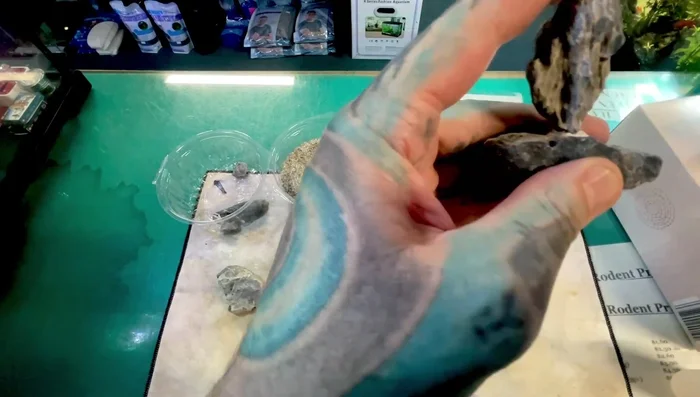 Place the glue-saturated tissue between the rocks, pressing firmly to create a strong bond. A chemical reaction will occur, producing bubbles and possibly a little smoke (well-ventilated area recommended).