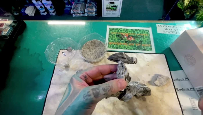 Add aquarium-safe sand or gravel to camouflage any visible glue or tissue paper.