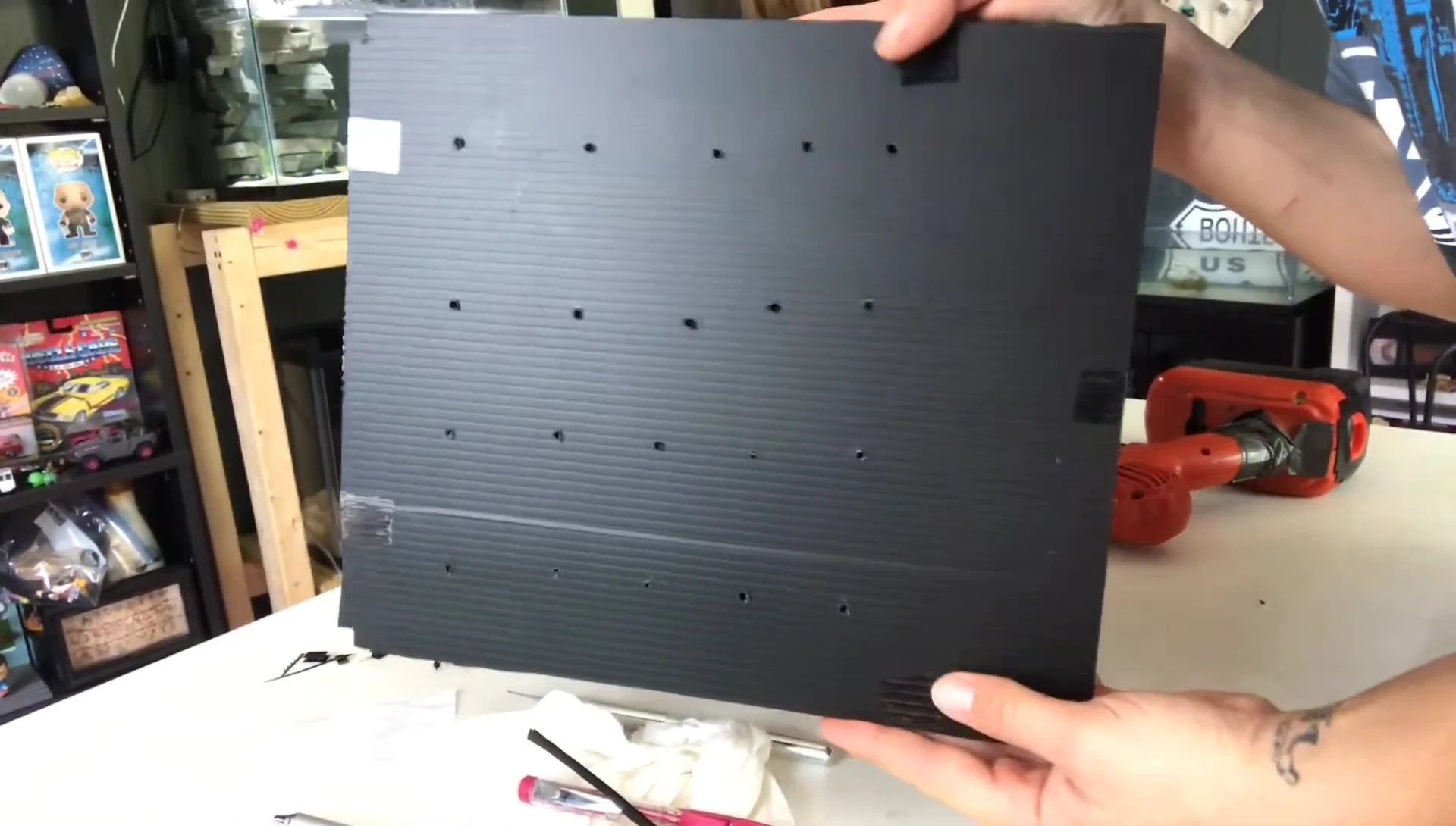 Sanding down the edges of the holes.