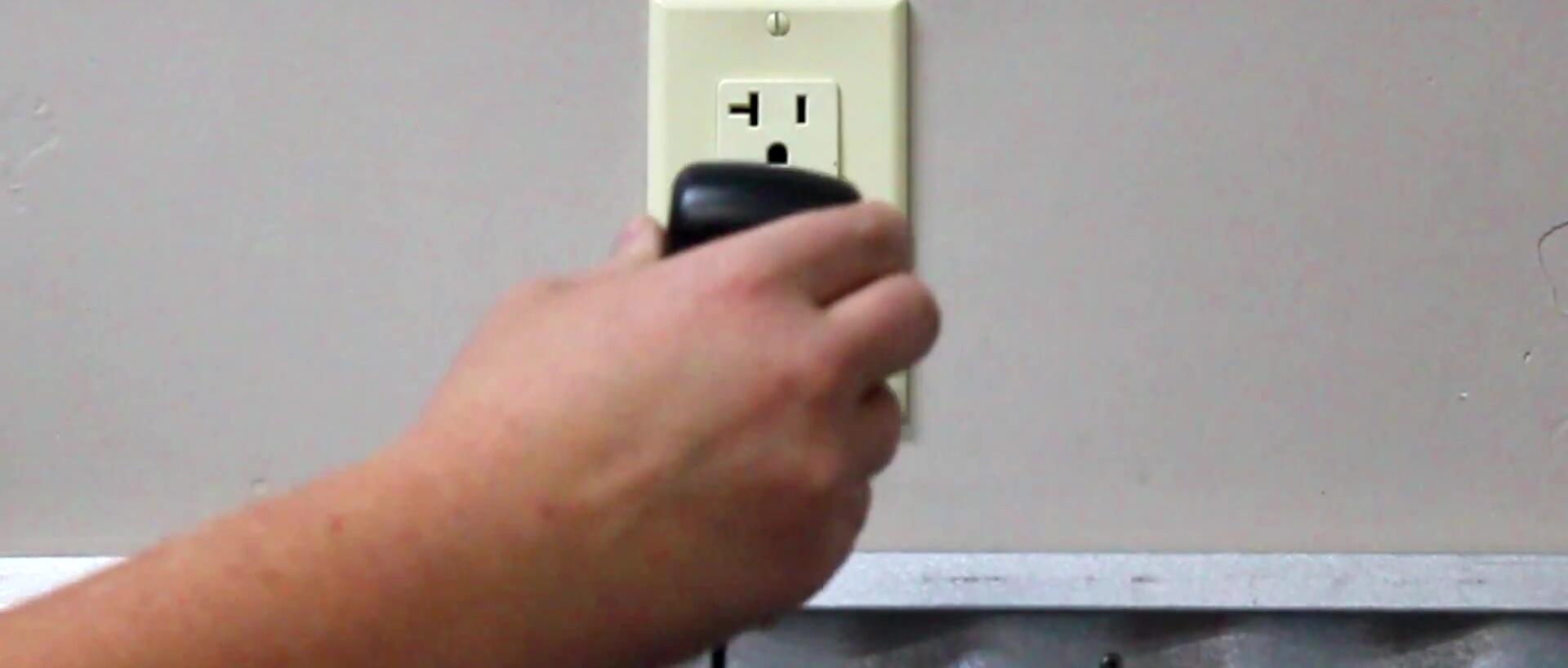 Person removing a module from the light fixture