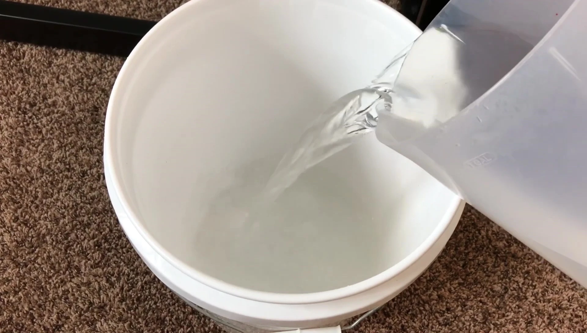 The narrator demonstrating how to clean the sponge filter using aquarium water.