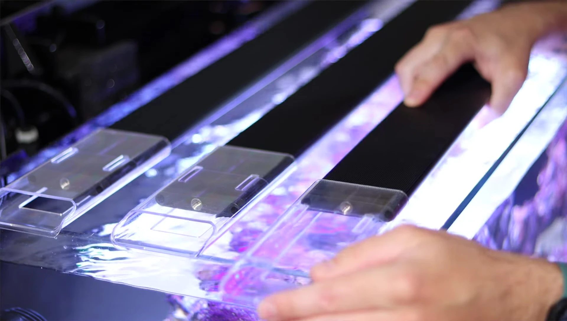 The AI Blade lights being installed on an aquarium