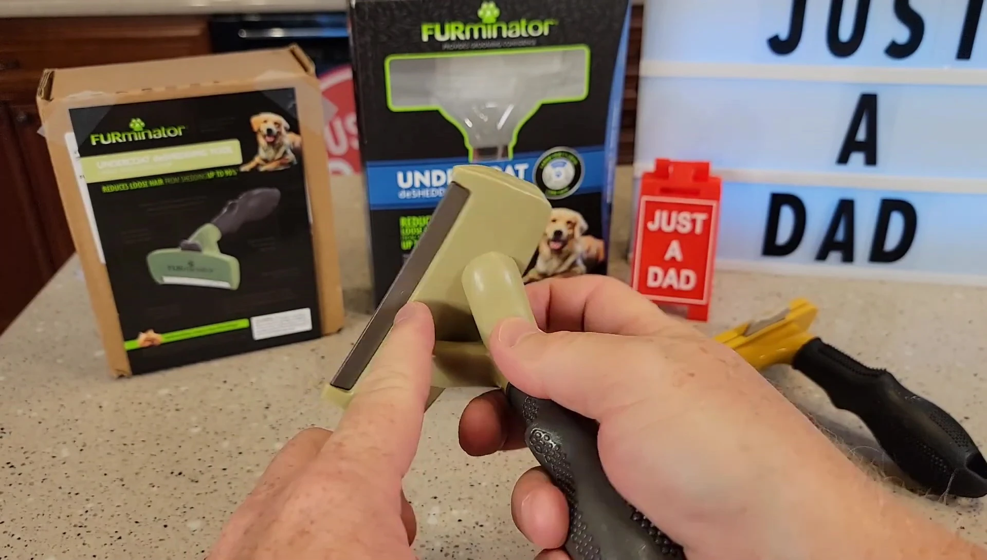 Close-up of the worn comb on the black FURminator tool