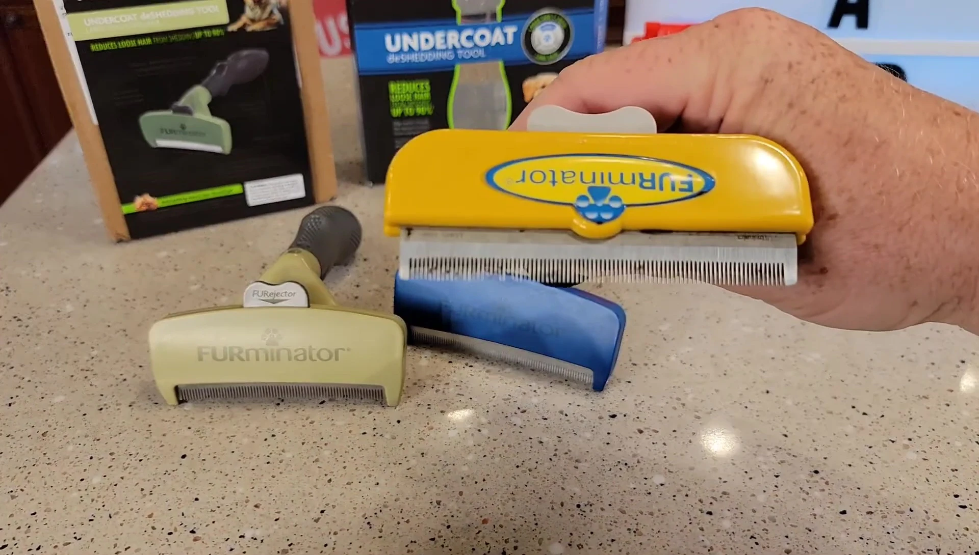 Close-up of the straight teeth on the green FURminator tool