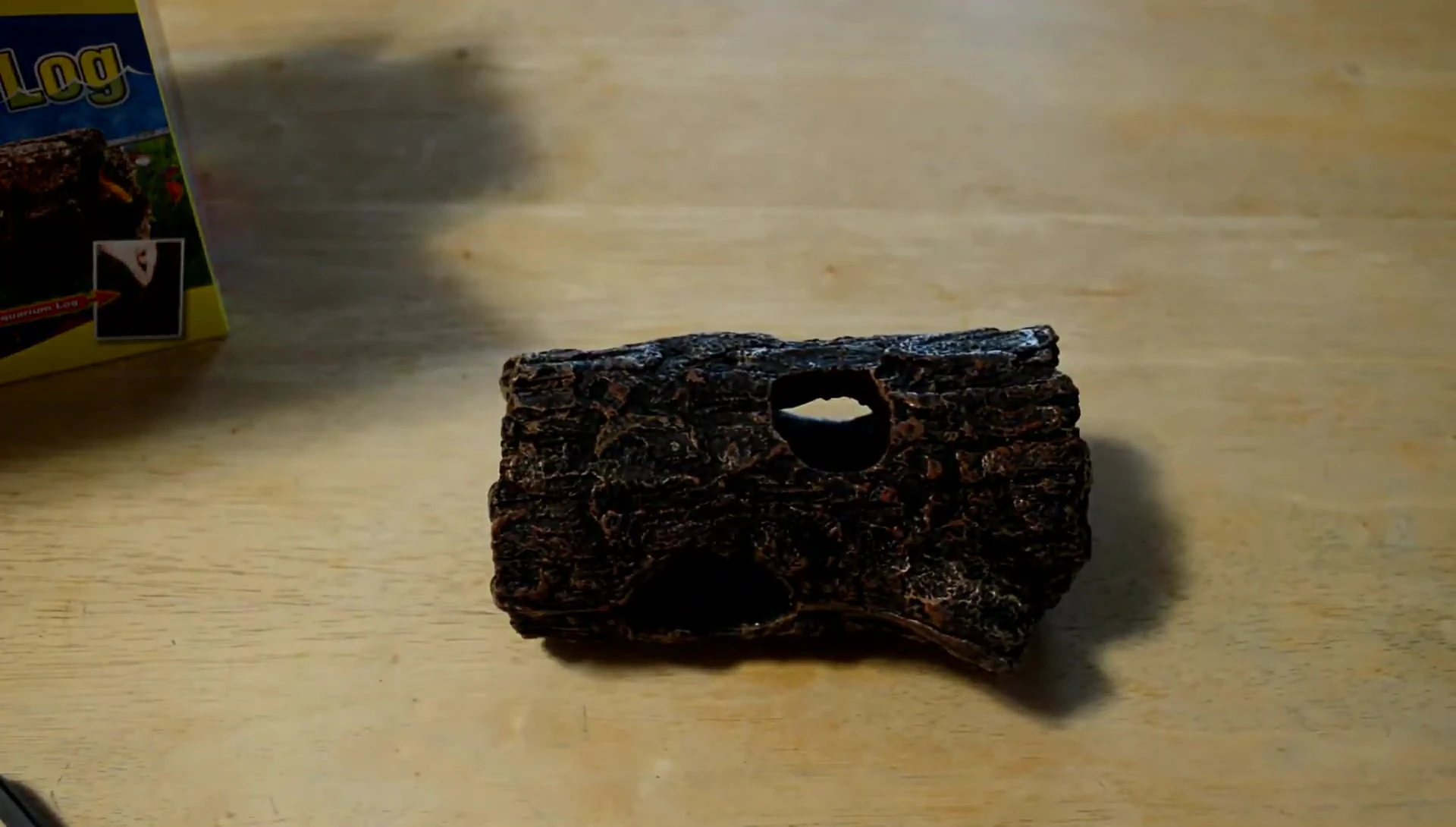 The log being placed in the fountain.
