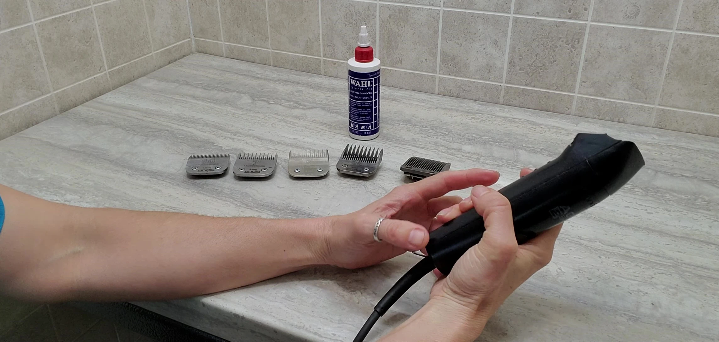 The groomer demonstrates the smooth design of the clippers.