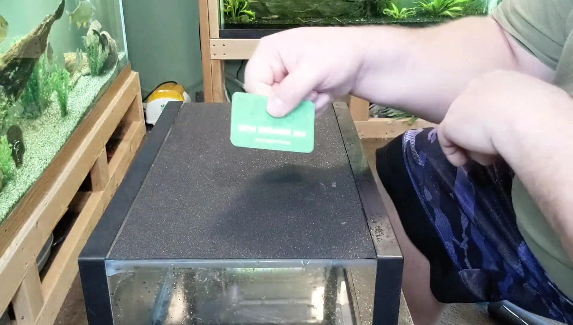 Smoothing out air bubbles with a credit card.