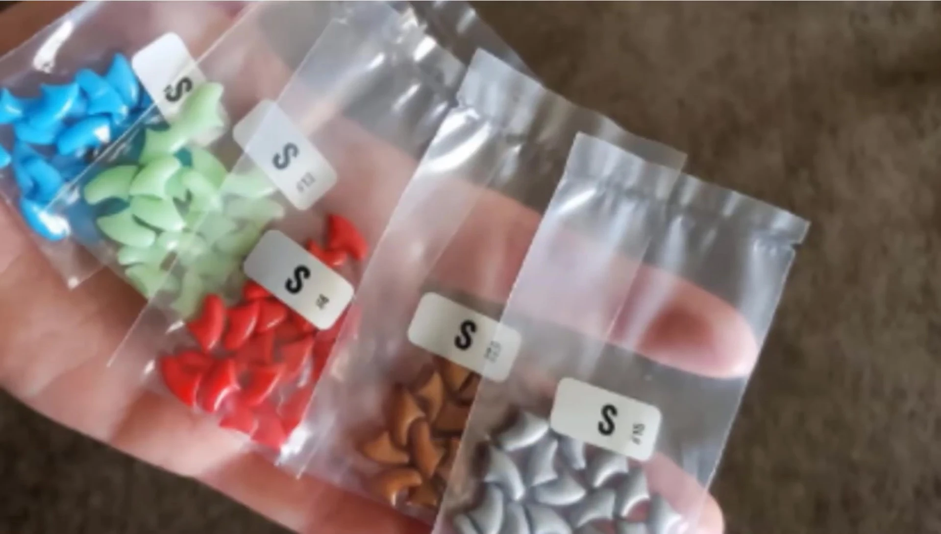 Cat showcasing vibrant Epo Cad nail caps