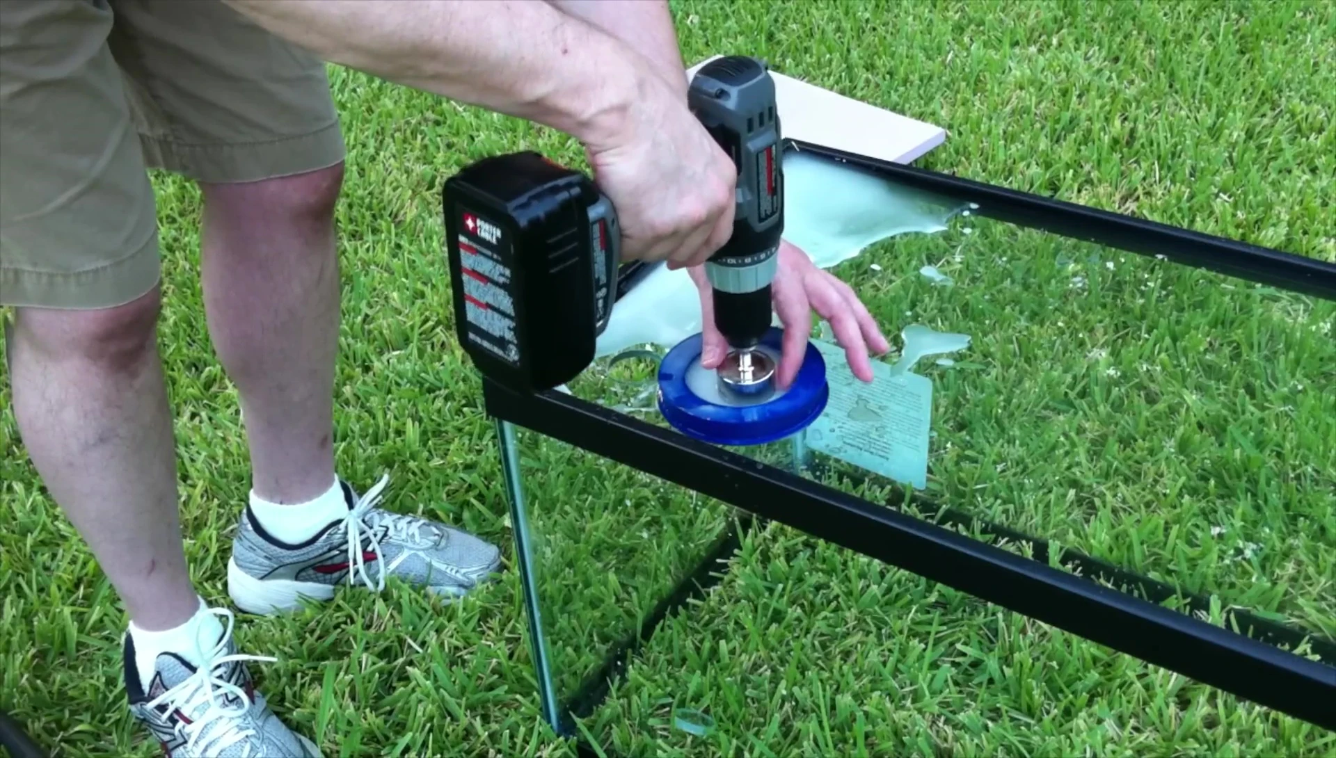 Person drilling a second hole, showing the process