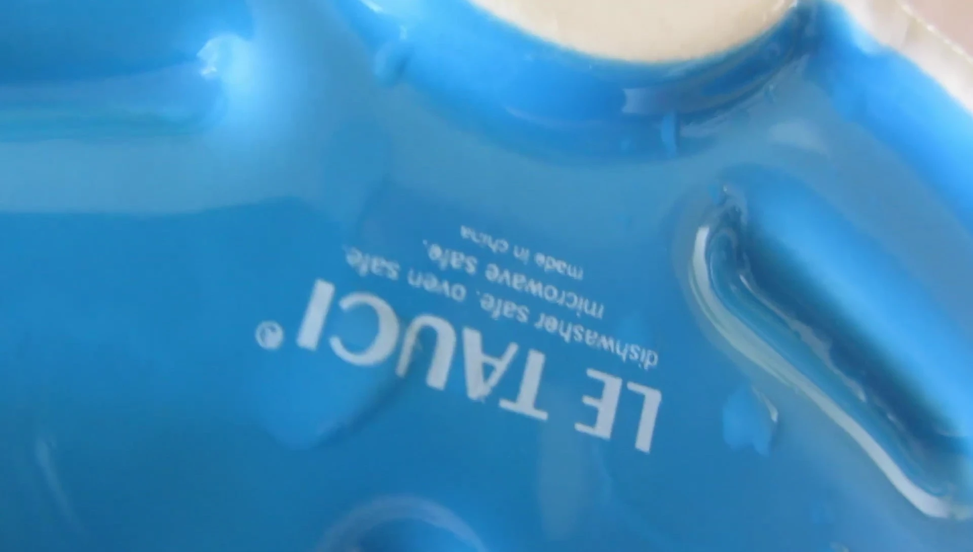 The bowl's base, highlighting the 'dishwasher safe' and 'microwave safe' markings.