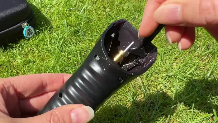 Use the brush to carefully clean around the internal components of the handset.