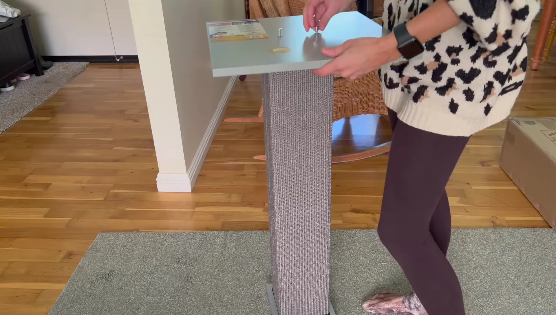 The reviewer demonstrating the ease of assembling the scratching post.