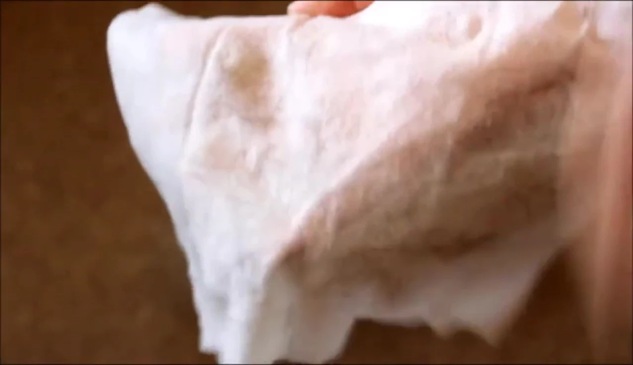 A used wipe displaying the dirt and hair removed.